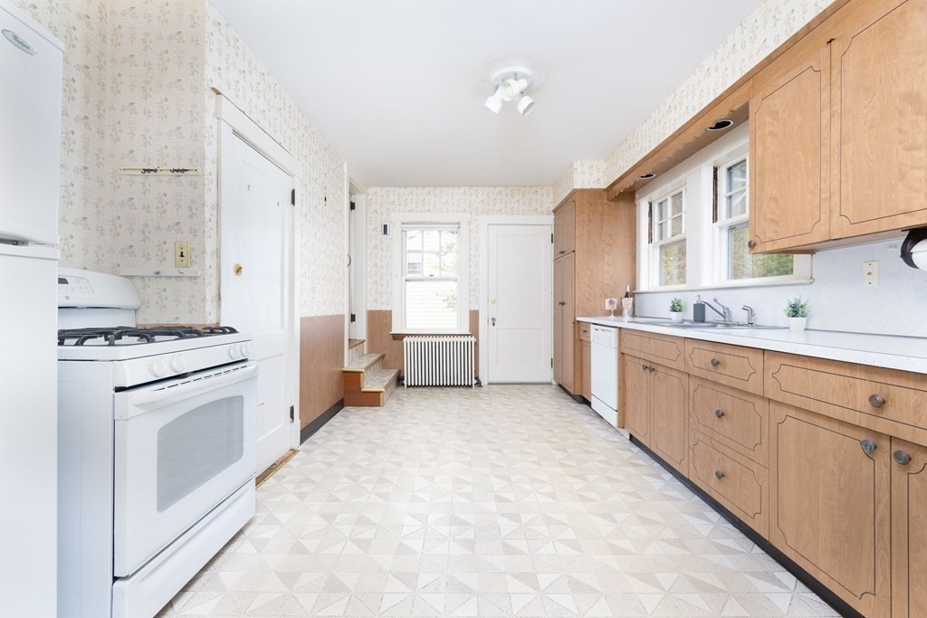 34 Brook Road Sharon, MA 02067 - Photo 10 of 19 a kitchen with white cabinets and white appliances