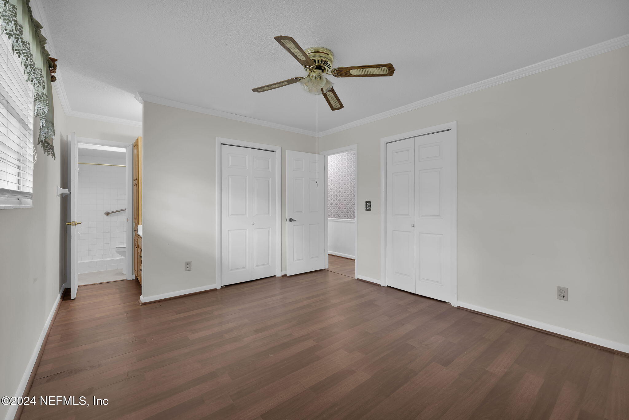 960 Grape Lane St. Johns, FL 32259 - Photo 20 of 46 an empty room with wooden floor ceiling fan and windows