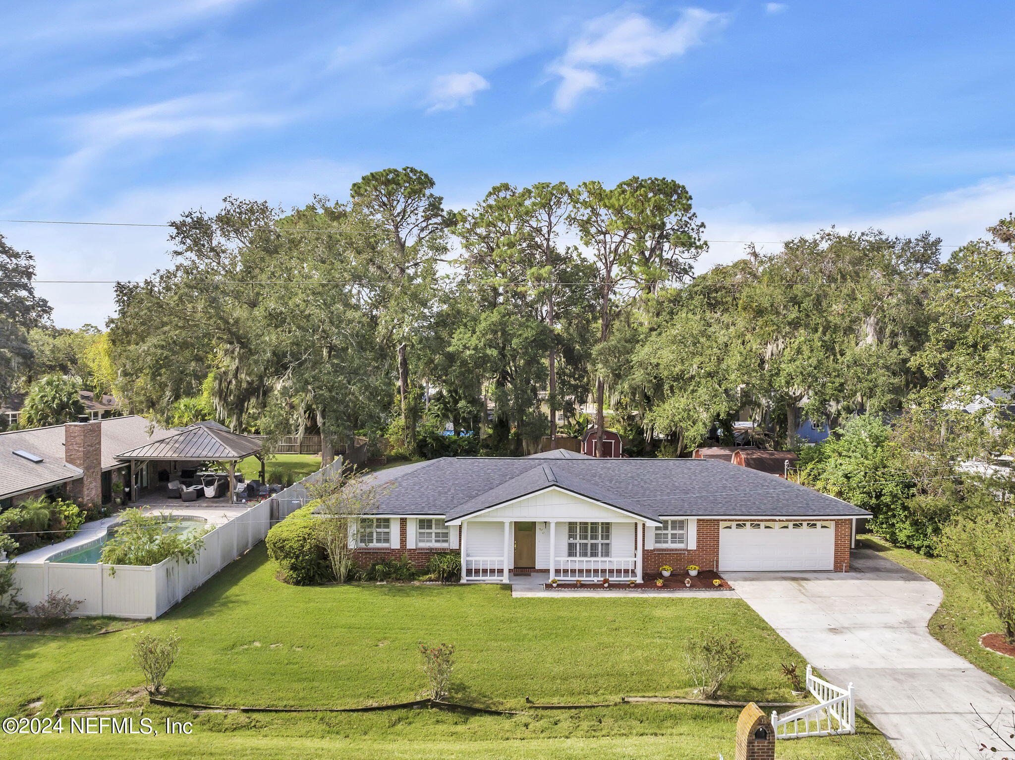 960 Grape Lane St. Johns, FL 32259 - Photo 38 of 46 a view of a white house with a yard plants and large tree