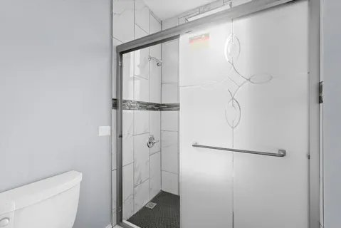 a view of cabinets a wooden floor and a window in the kitchen