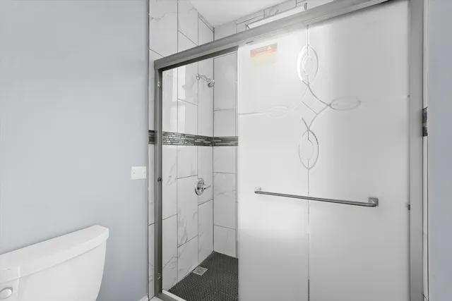 a view of cabinets a wooden floor and a window in the kitchen