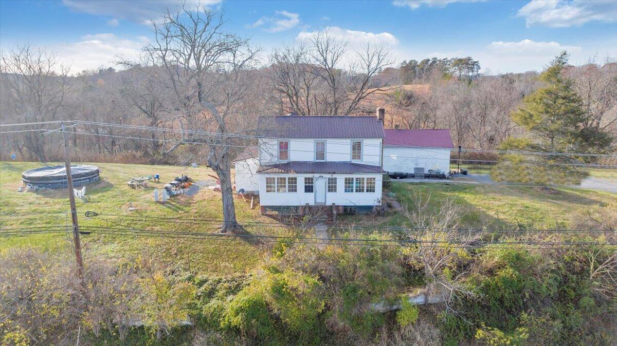 6457 Roanoke Road Fincastle, VA 24090 - Photo 4 of 34 a view of a lake with a building in the background