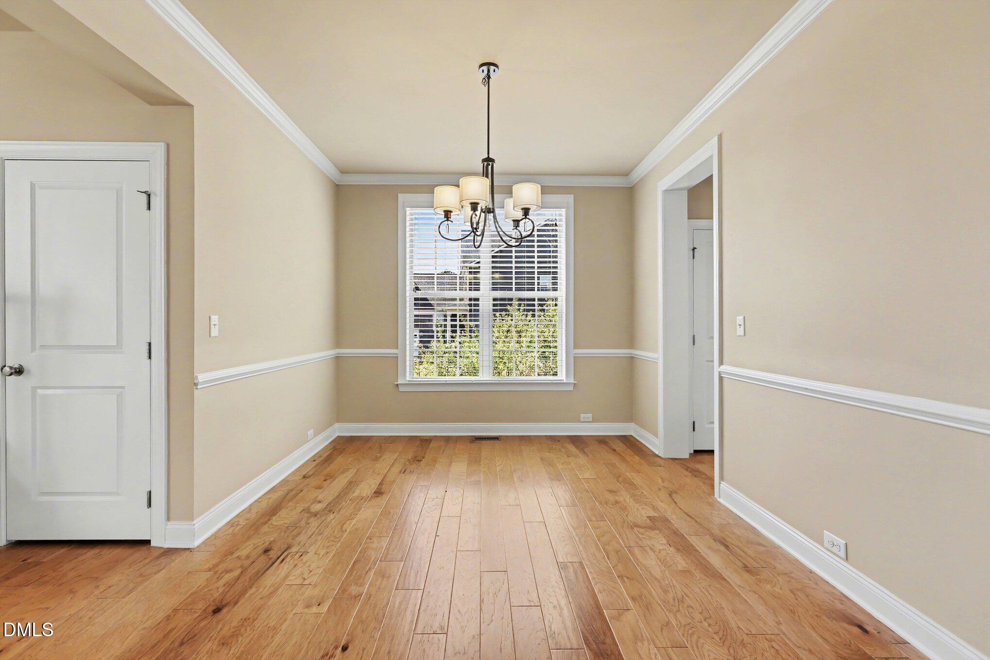 351 Gartrell Way Cary, NC 27519 - Photo 12 of 51 a view of empty room with wooden floor and fan