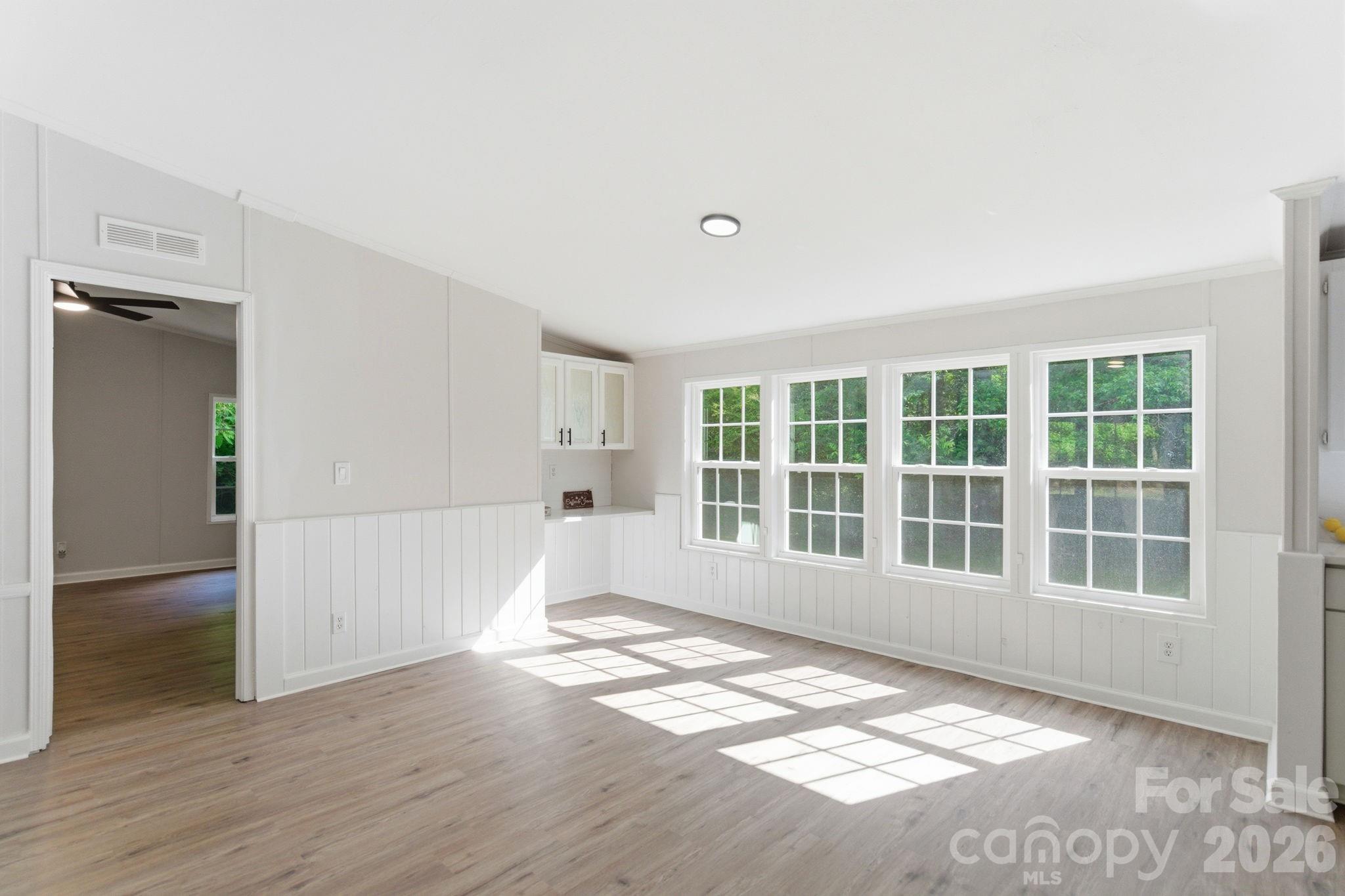481 Harrell Road Burgaw, NC 28425 - Photo 8 of 25 an empty room with wooden floor and windows