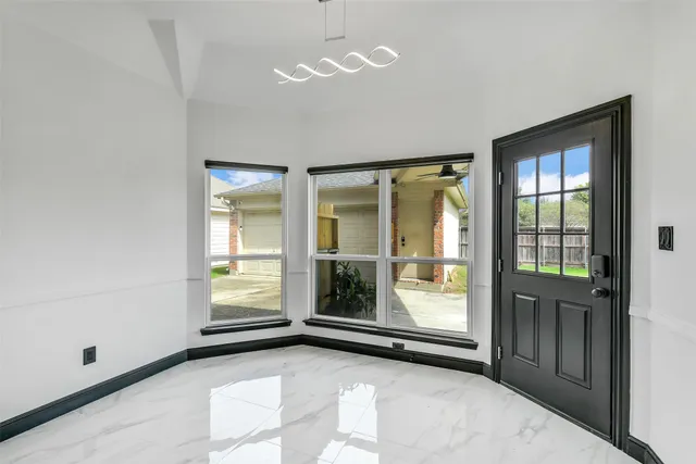 a view of a living room hardwood floor and a window