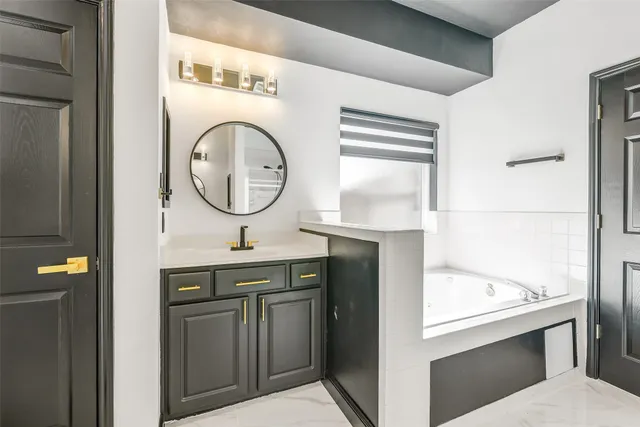 a bathroom with a bathtub and a window