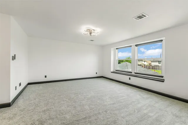 an empty room with a projector and a window