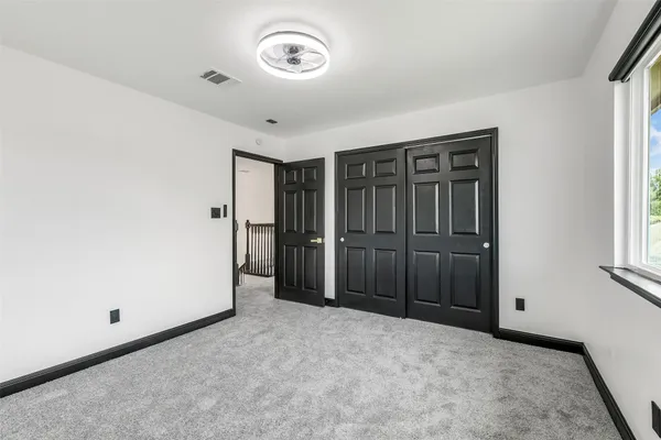 an empty room with a empty space and windows