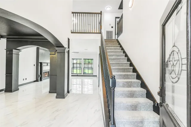 a view of an entryway with wooden floor and stairs