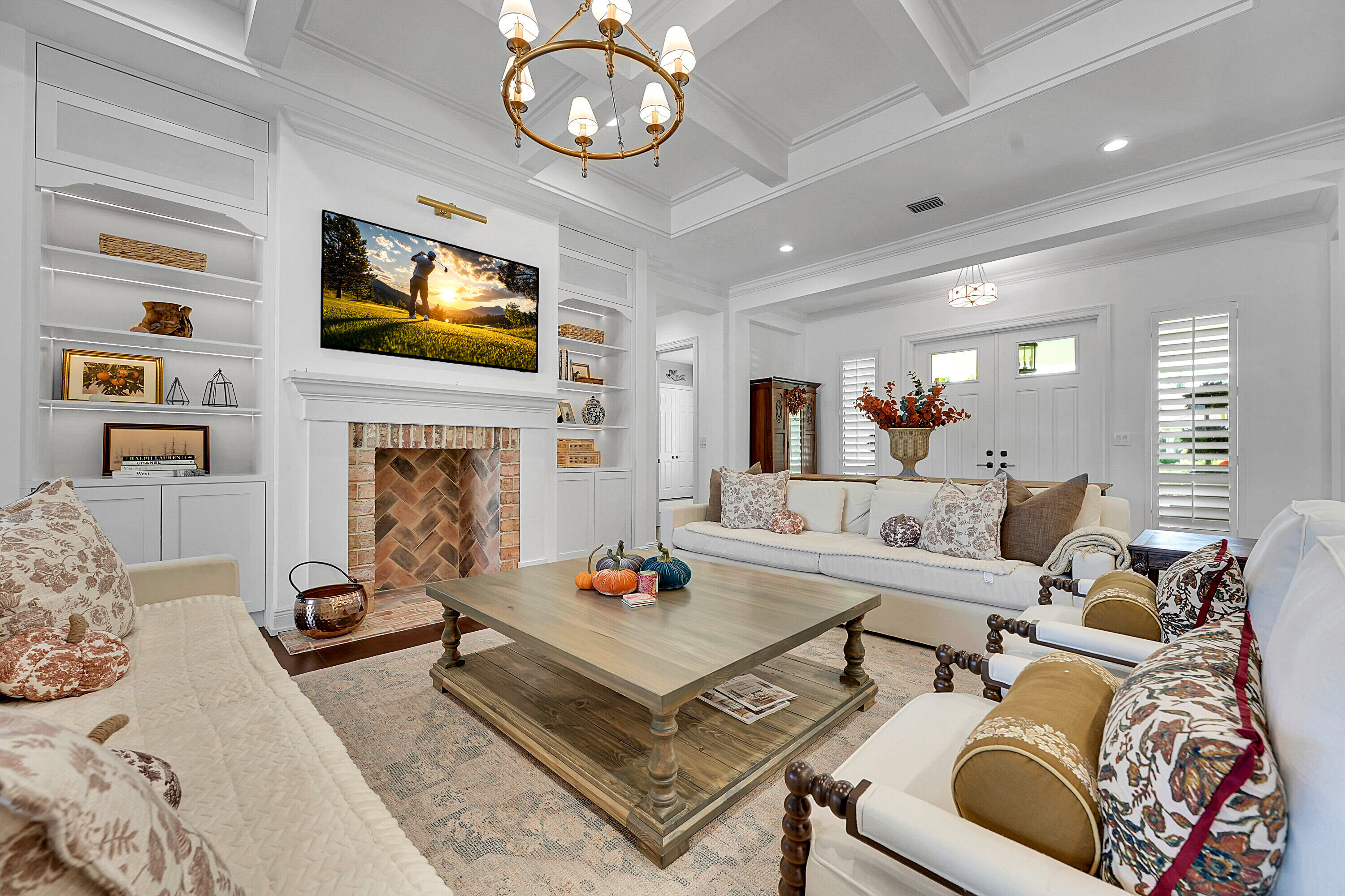 7660 Bold Lad Road Palm Beach Gardens, FL 33418 - Photo 16 of 68 a living room with furniture a flat screen tv and a fireplace
