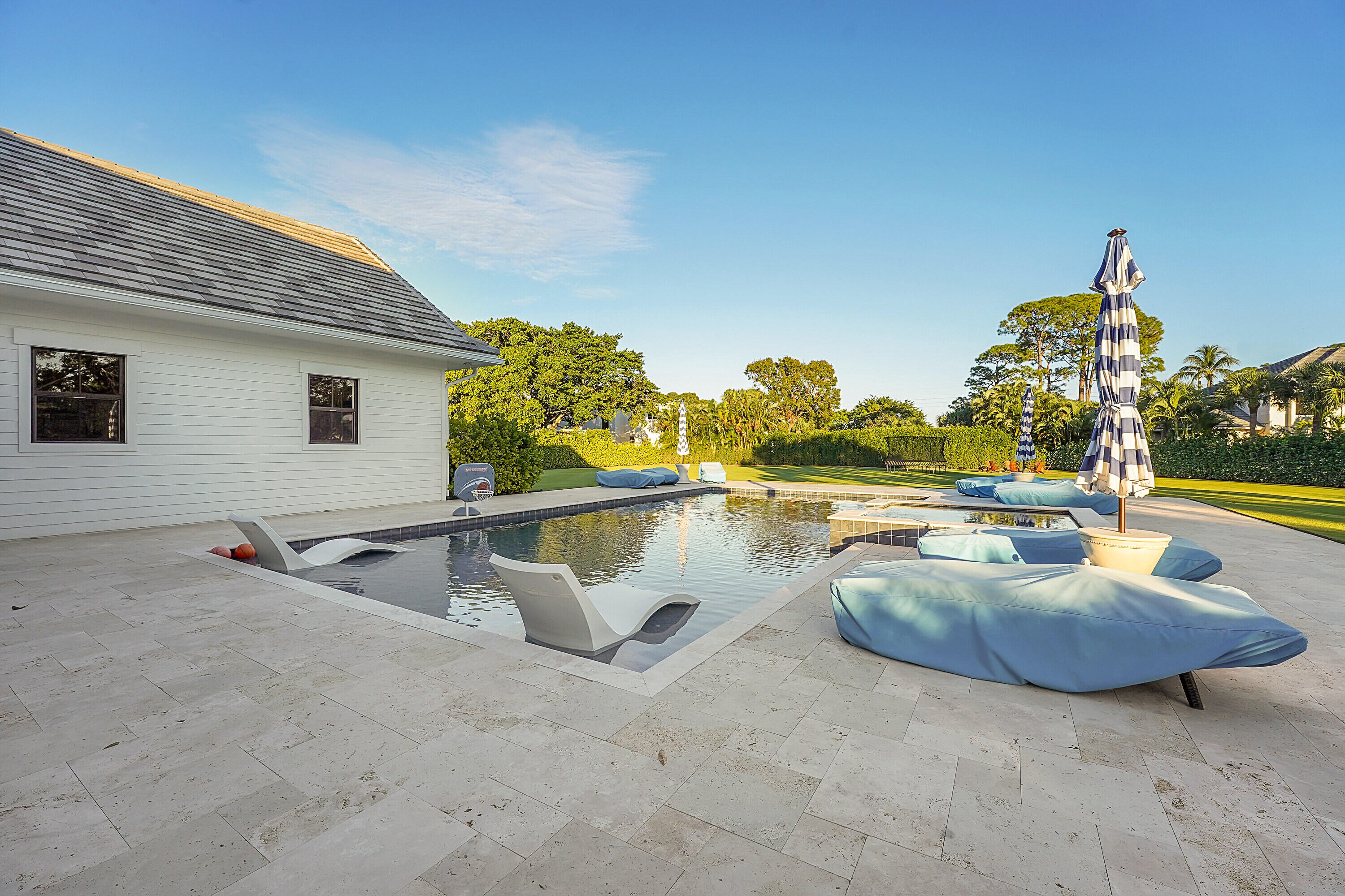 7660 Bold Lad Road Palm Beach Gardens, FL 33418 - Photo 37 of 68 a view of swimming pool with outdoor seating and plants