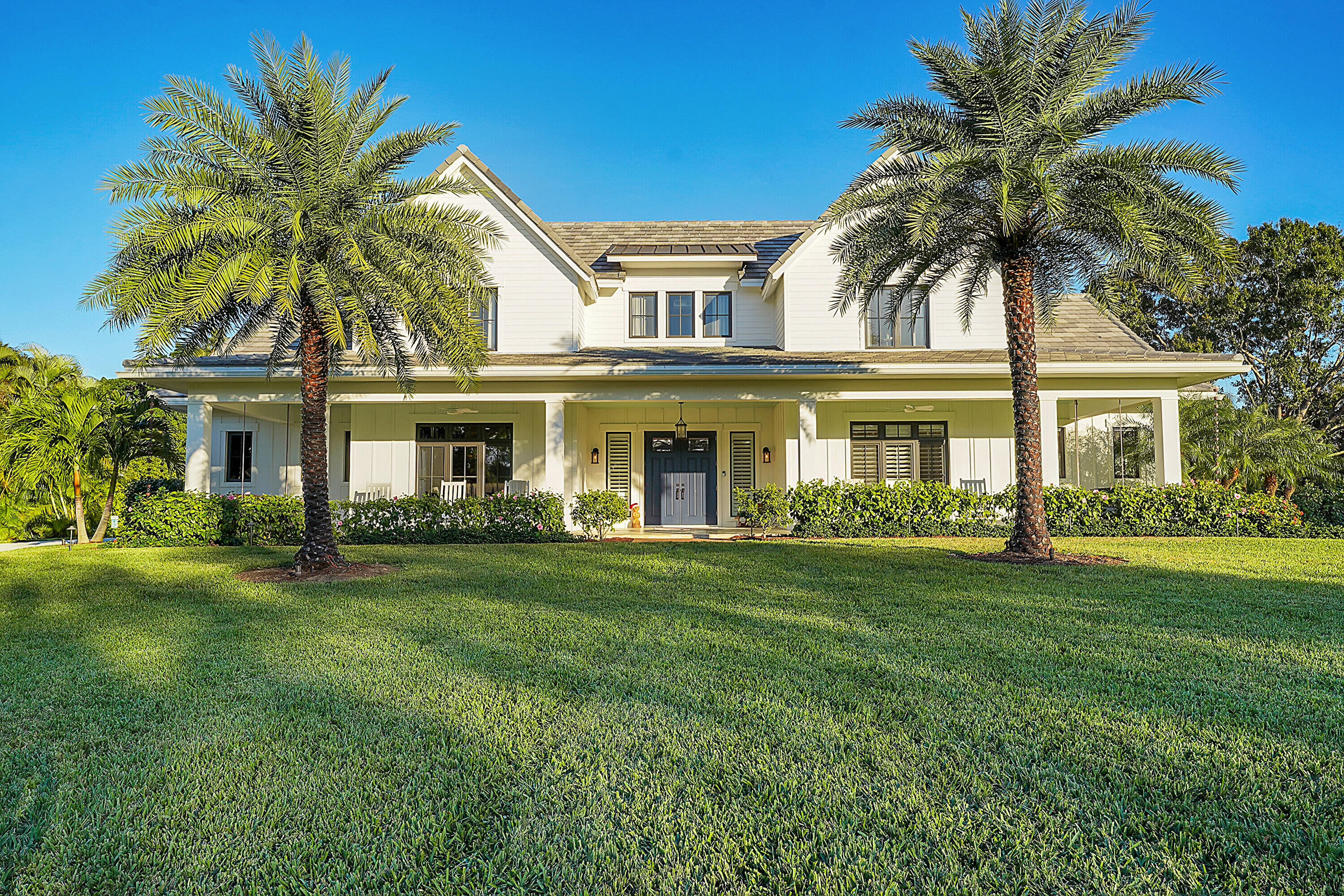 7660 Bold Lad Road Palm Beach Gardens, FL 33418 - Photo 60 of 68 front view of a house with a garden