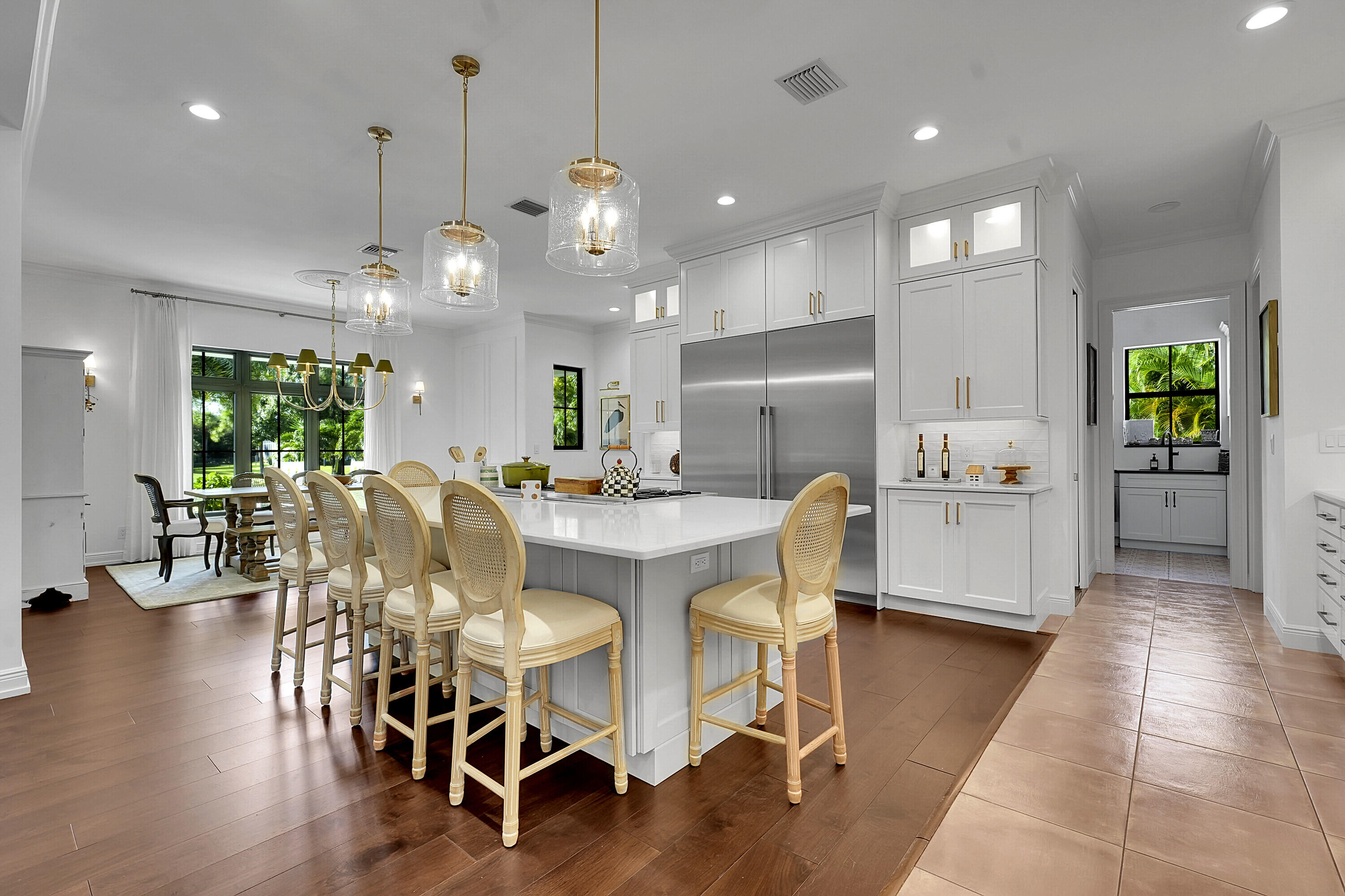 7660 Bold Lad Road Palm Beach Gardens, FL 33418 - Photo 9 of 68 a large kitchen with a table and chairs in it