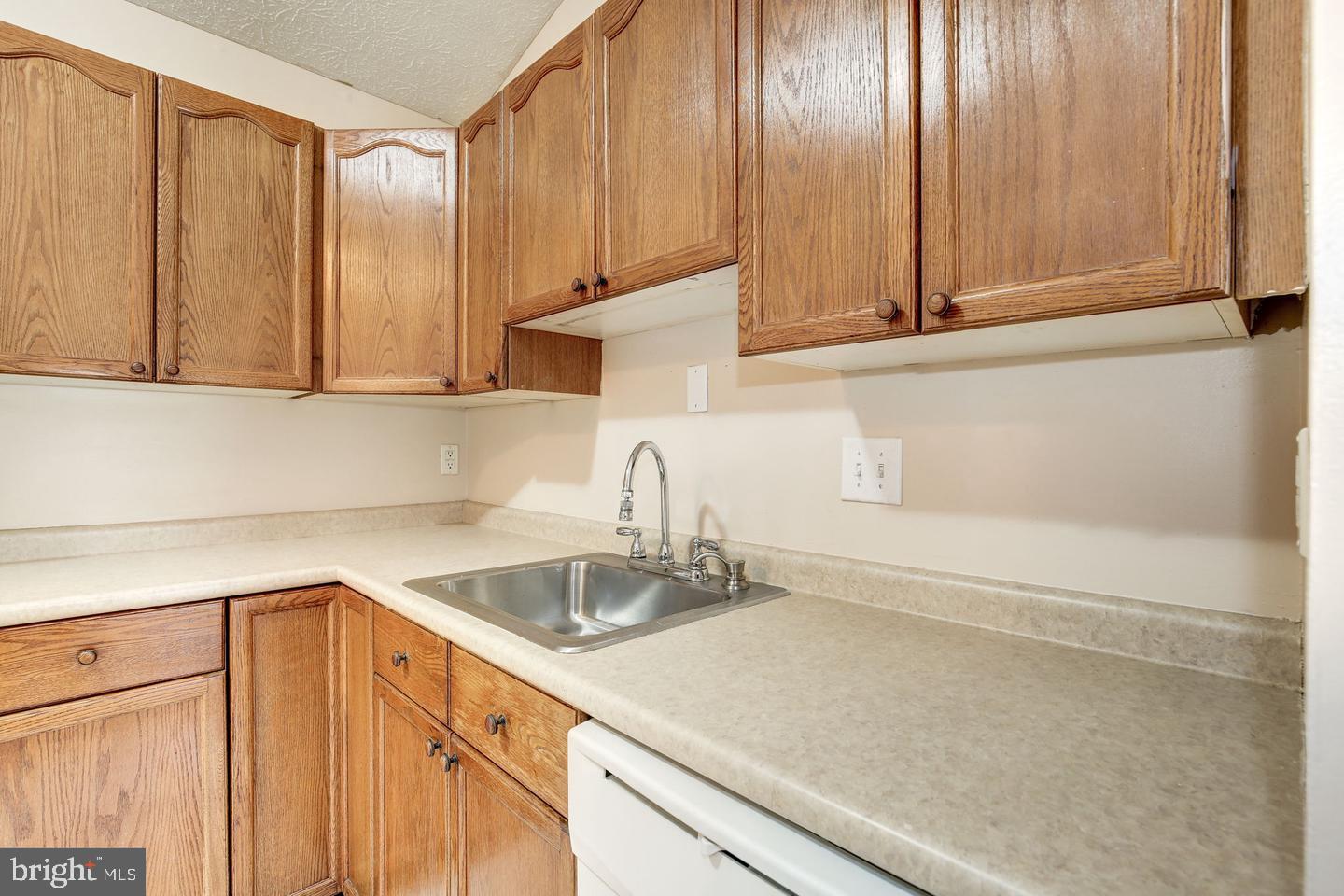 2106 Whitehall Road, Unit 2D Frederick, MD 21702 - Photo 15 of 33 a kitchen with a sink cabinets and a wooden floor