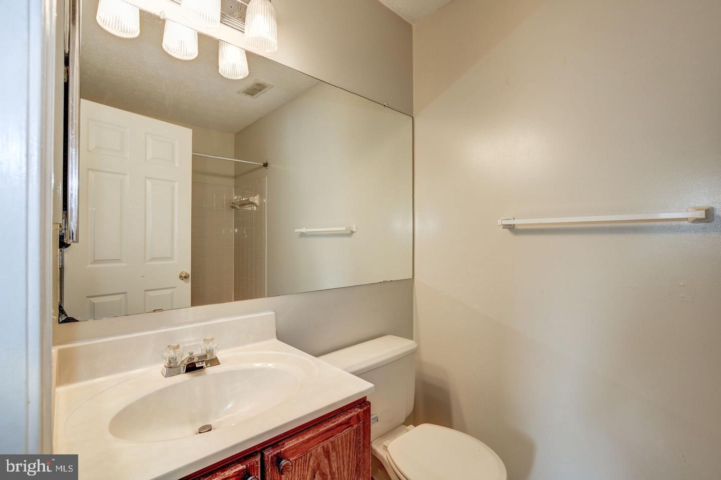 2106 Whitehall Road, Unit 2D Frederick, MD 21702 - Photo 24 of 33 a bathroom with a sink mirror and toilet