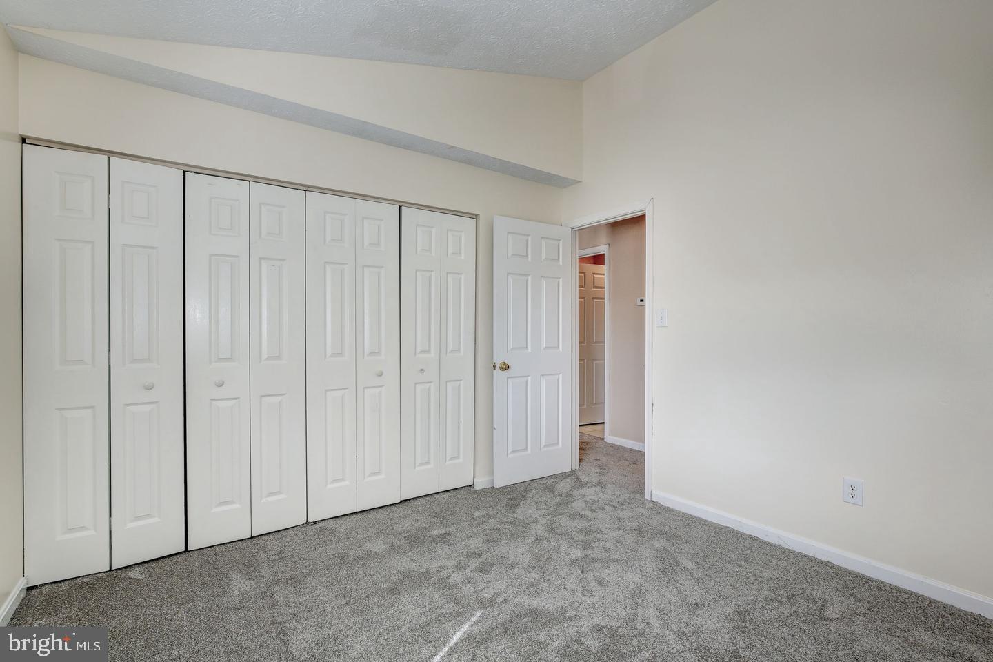 2106 Whitehall Road, Unit 2D Frederick, MD 21702 - Photo 28 of 33 an empty room with a wooden door
