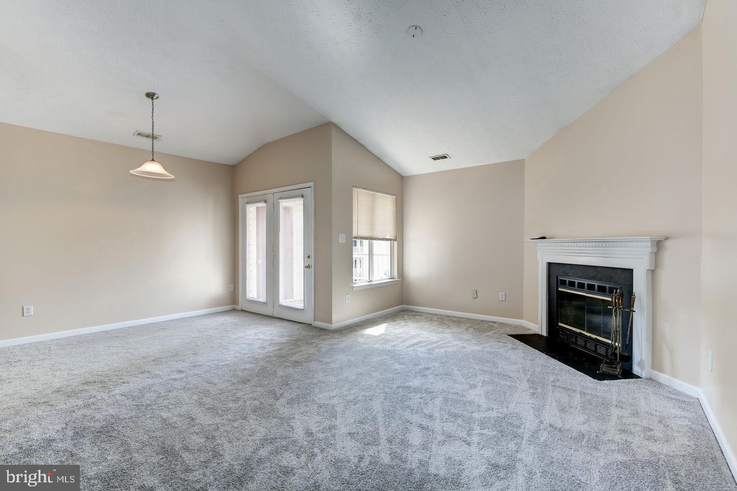 2106 Whitehall Road, Unit 2D Frederick, MD 21702 - Photo 5 of 33 an empty room with windows and fireplace