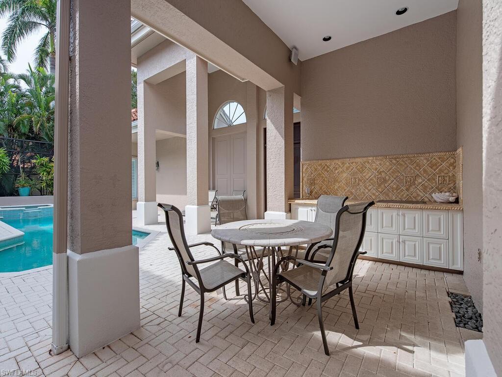 2080 Gordon Drive Naples, FL 34102 - Photo 17 of 25 a view of a dining room with furniture and window