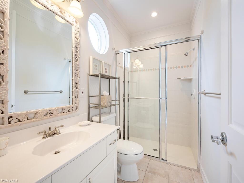 2080 Gordon Drive Naples, FL 34102 - Photo 19 of 25 a bathroom with a sink a toilet and shower