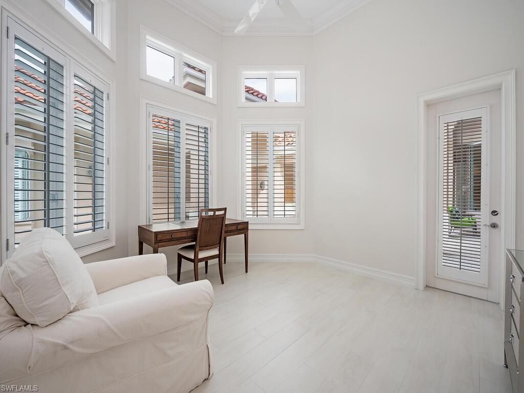 2080 Gordon Drive Naples, FL 34102 - Photo 22 of 25 a living room with furniture and large windows