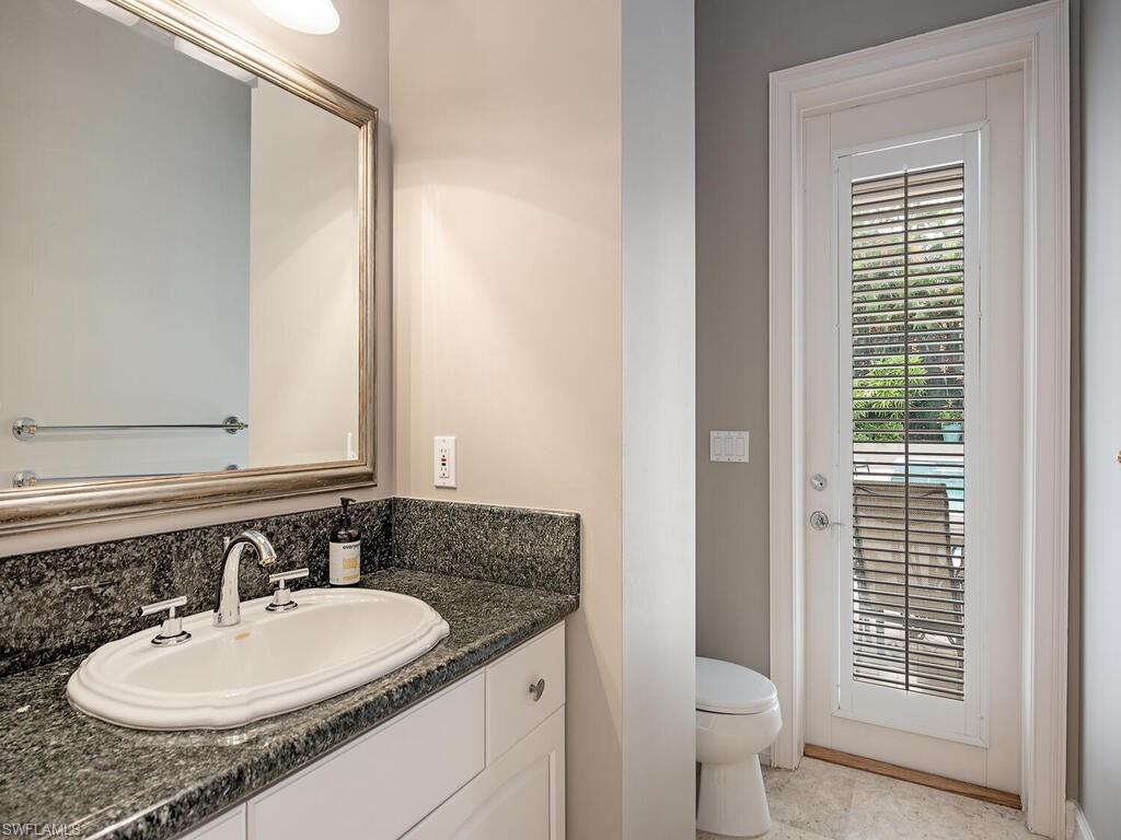 2080 Gordon Drive Naples, FL 34102 - Photo 25 of 25 a bathroom with a granite countertop sink toilet and shower