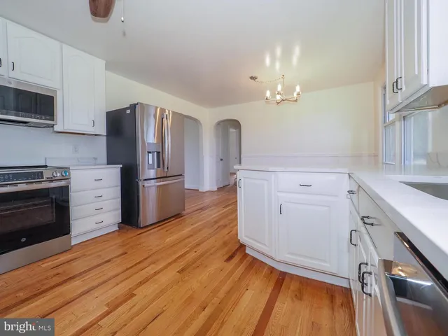 a kitchen with stainless steel appliances a stove refrigerator and cabinets
