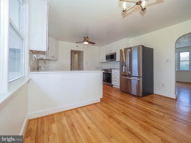a kitchen with stainless steel appliances a refrigerator and a stove top oven