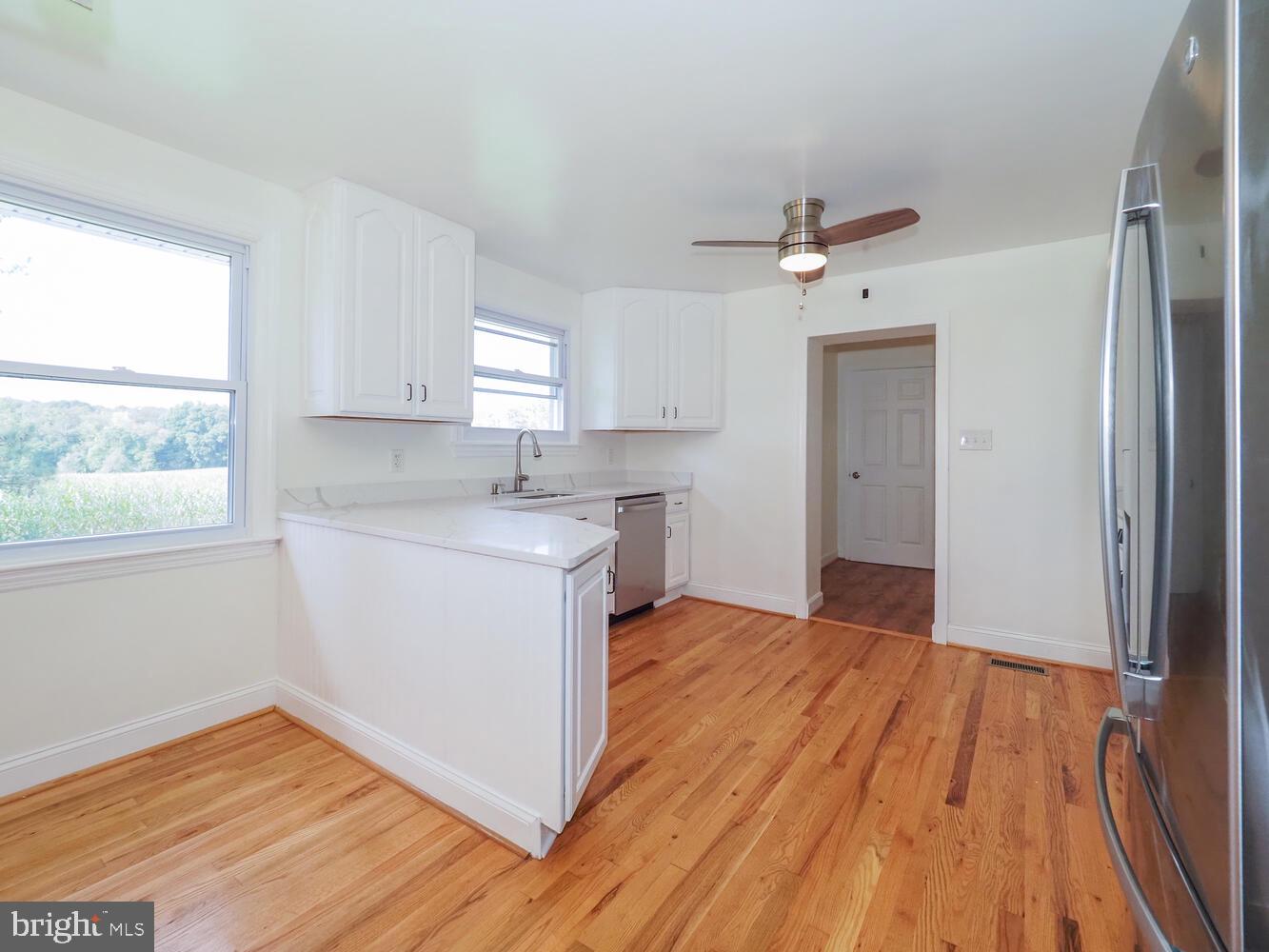 418 Hiobs Lane Aberdeen, MD 21001 - Photo 22 of 46 a view of a kitchen with wooden floor and a window