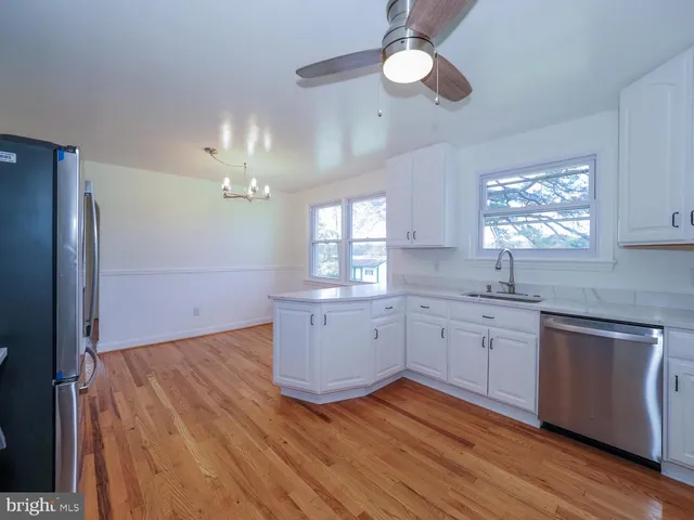 a kitchen with sink cabinets and wooden floor