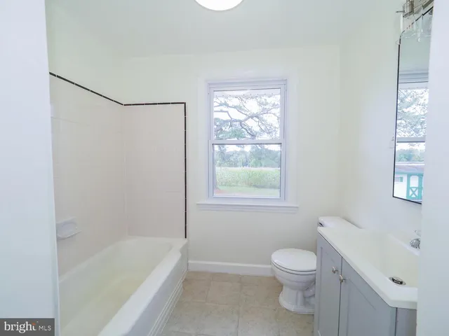 a bathroom with a toilet a sink and bathtub