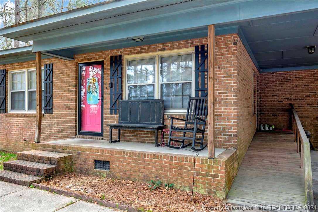 527 Old Allenton Road Lumberton, NC 28358 - Photo 2 of 20 a view of a brick house with large windows