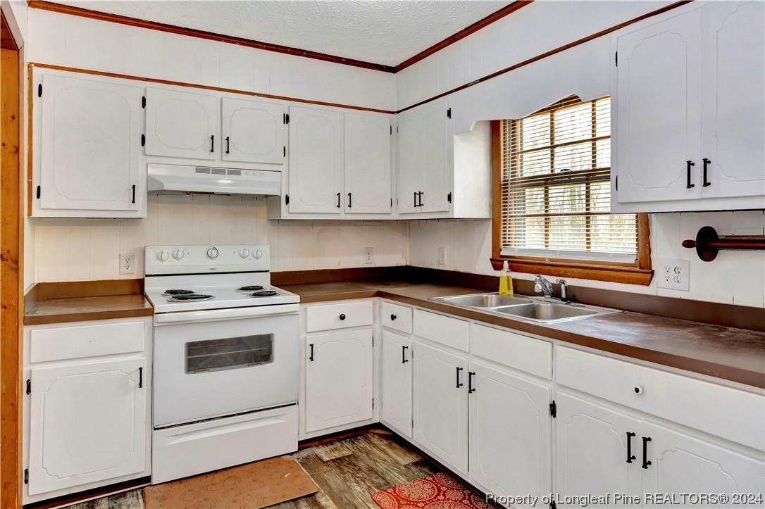 527 Old Allenton Road Lumberton, NC 28358 - Photo 7 of 20 a kitchen with cabinets appliances a sink and a window