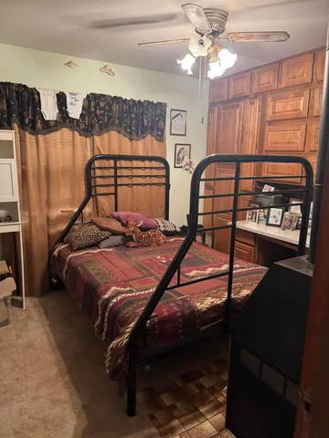 a bed sitting in a bedroom next to a window