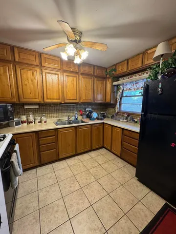a kitchen with stainless steel appliances granite countertop a stove sink and cabinets