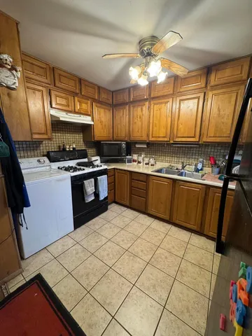 a kitchen with stainless steel appliances a stove a sink and a refrigerator