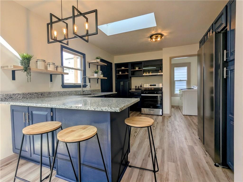 310 East Penn Street Butler, PA 16001 - Photo 11 of 30 a kitchen with granite countertop a counter space dining table and stainless steel appliances