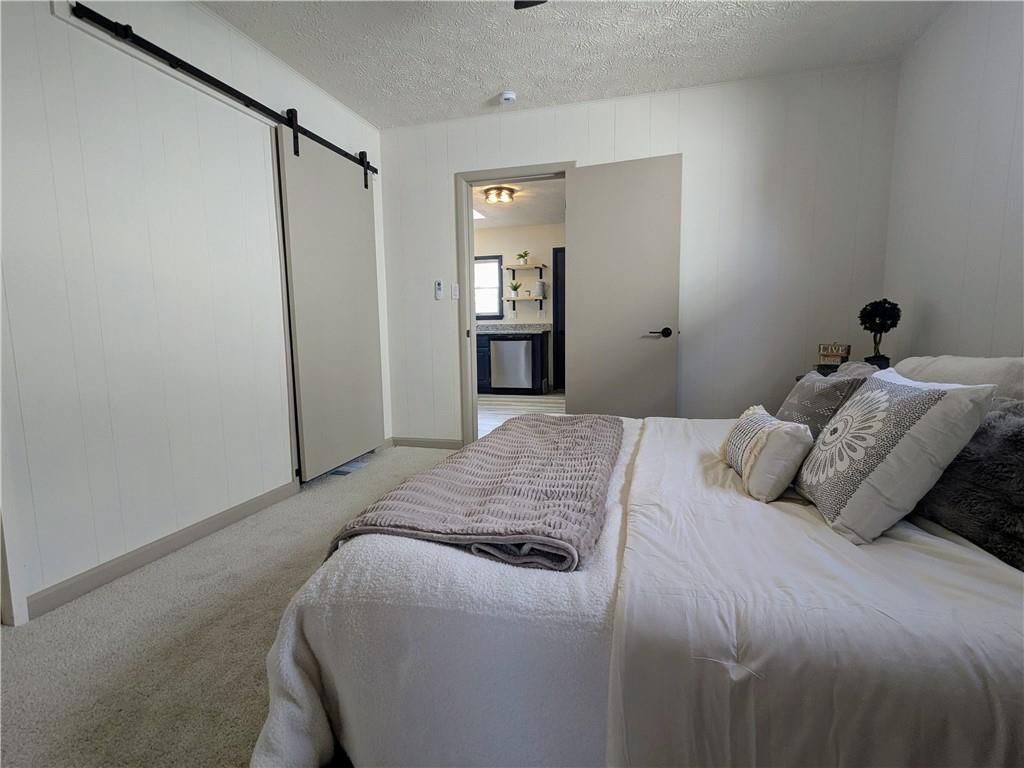 310 East Penn Street Butler, PA 16001 - Photo 14 of 30 a bedroom with a large bed and closet