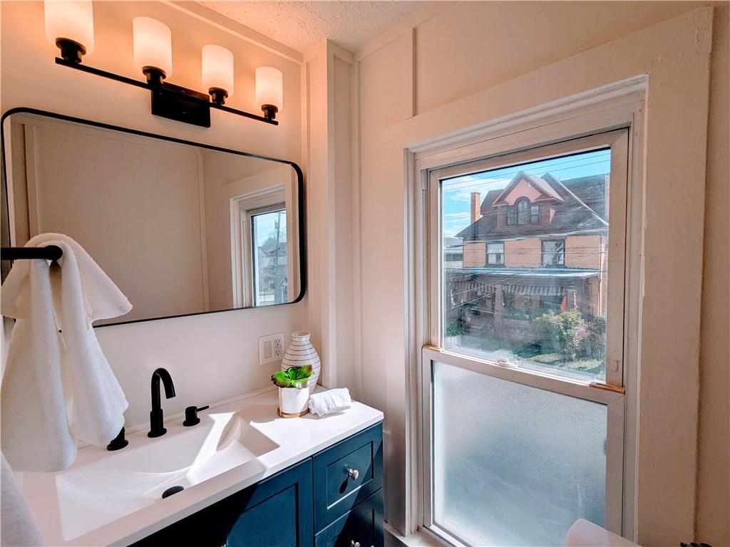 310 East Penn Street Butler, PA 16001 - Photo 24 of 30 a bathroom with a sink mirror and vanity
