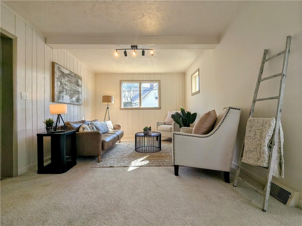 310 East Penn Street Butler, PA 16001 - Photo 4 of 30 a living room with furniture and a chandelier