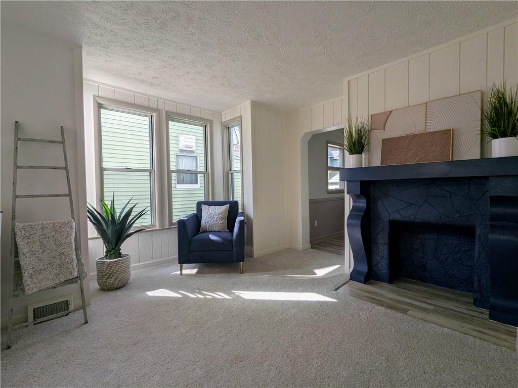 310 East Penn Street Butler, PA 16001 - Photo 5 of 30 a living room with furniture and a fireplace