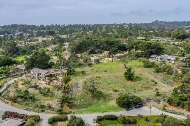 an aerial view of a houses with a yard
