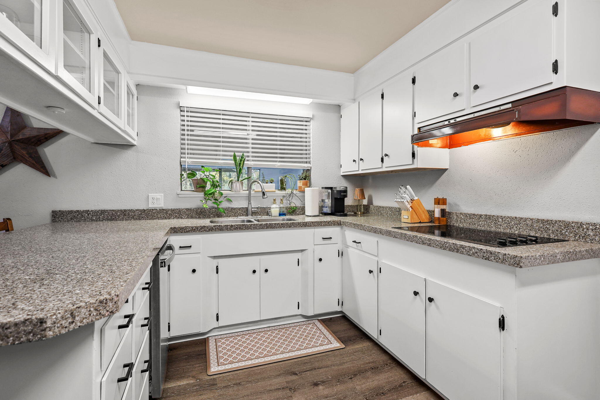 6958 Riverside Drive Redding, CA 96001 - Photo 9 of 30 a kitchen with granite countertop white cabinets and a sink