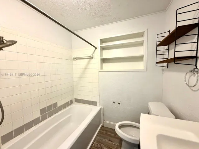 a bathroom with a toilet a sink and bathtub
