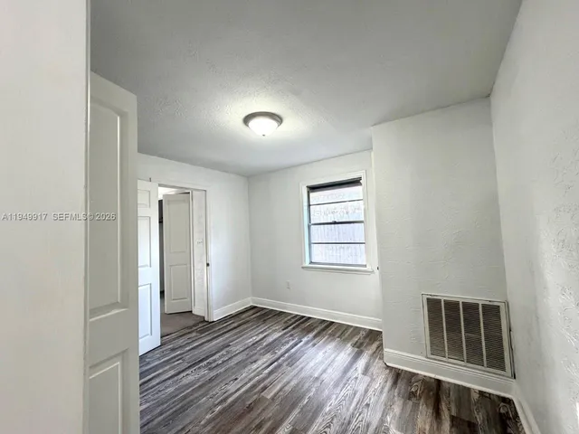 a view of wooden floor and windows in a room