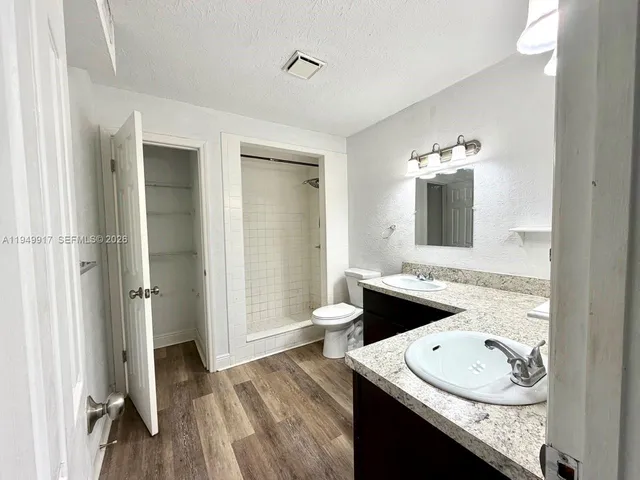 a bathroom with a sink double vanity and a mirror