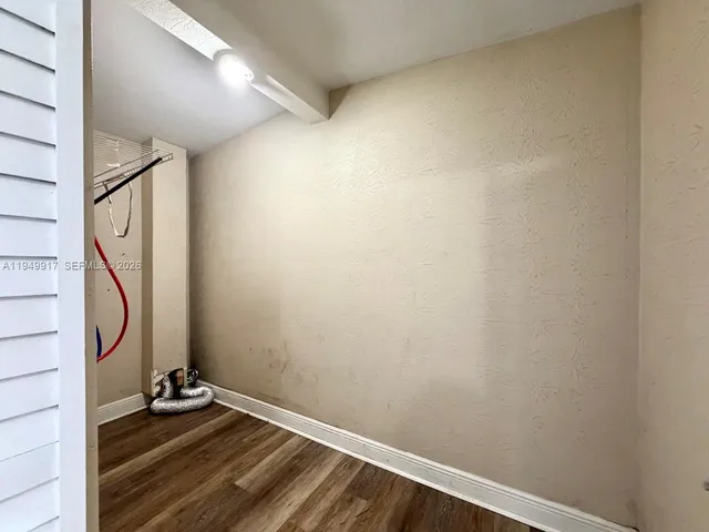 a view of an entryway with wooden floor