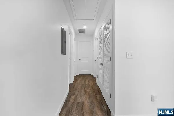 a view of a hallway with wooden floor