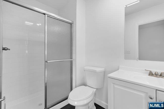 2 Rossi Court, Unit 2 South Hackensack, NJ 07606 - Photo 18 of 20 a bathroom with a toilet a sink and vanity