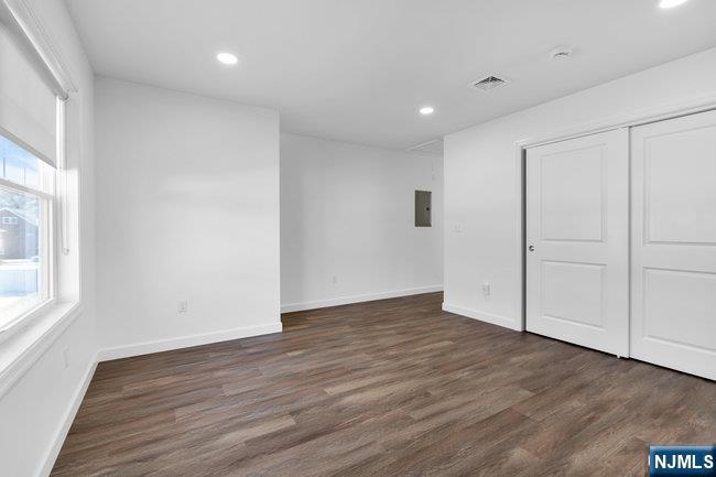 2 Rossi Court, Unit 2 South Hackensack, NJ 07606 - Photo 3 of 20 a view of an empty room with wooden floor and a window