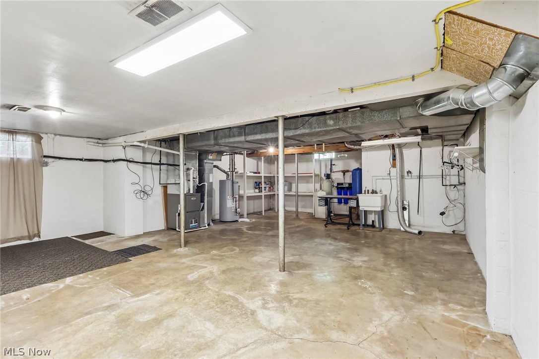1638 South Cleveland Massillon Road Akron, OH 44321 - Photo 27 of 37 Unfinished basement with concrete flooring, exposed utility lines, and structural support beams